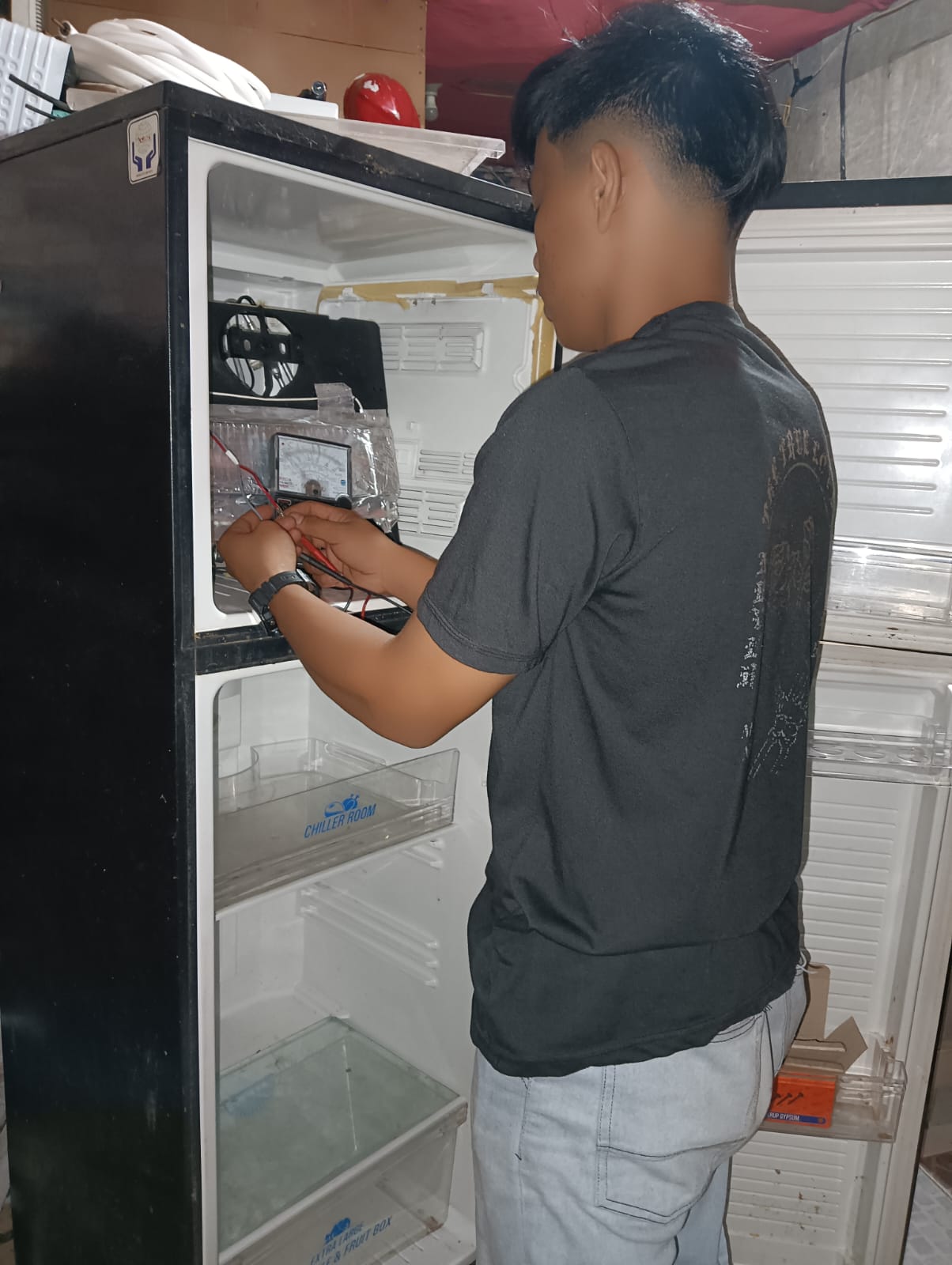 Teknisi memperbaiki kulkas dua pintu